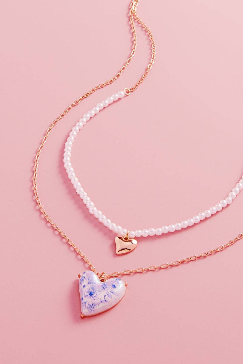 Necklace with heart-shaped pendant on a pink background