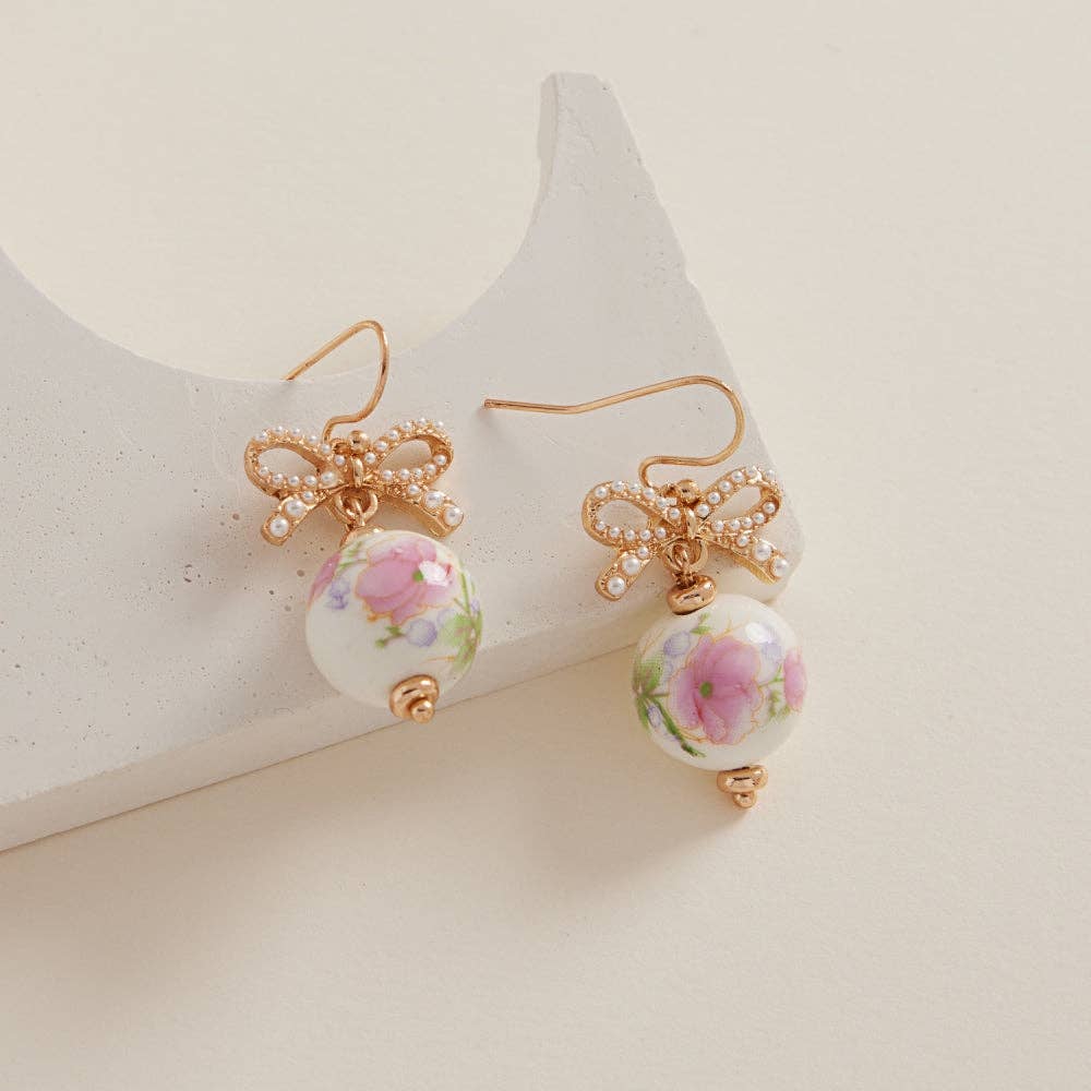 Round-shaped ceramic bead brass hook earrings by Designature New York featuring minimalist ceramic beads and brass hooks.