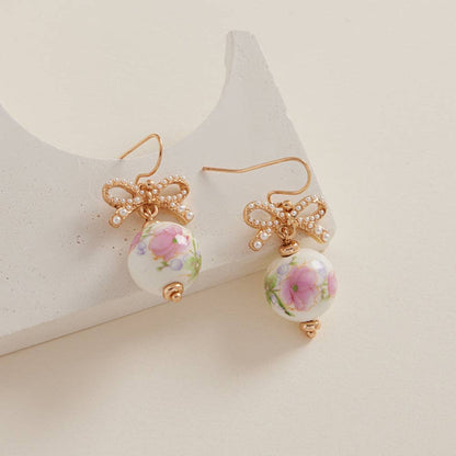Round-shaped ceramic bead brass hook earrings by Designature New York featuring minimalist ceramic beads and brass hooks.