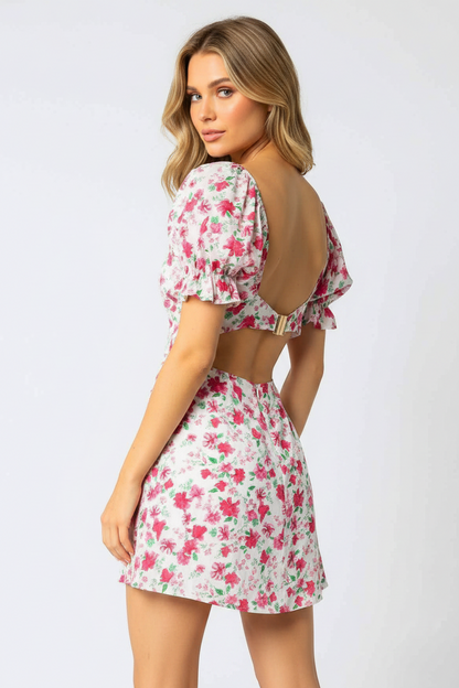 Back view of essecoco Adeline floral halter dress in pink with a ruffled hem and tied back detail.