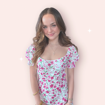 Esscoco Adeline floral halter dress with vibrant flower pattern and flowing fabric, displayed on a mannequin.
