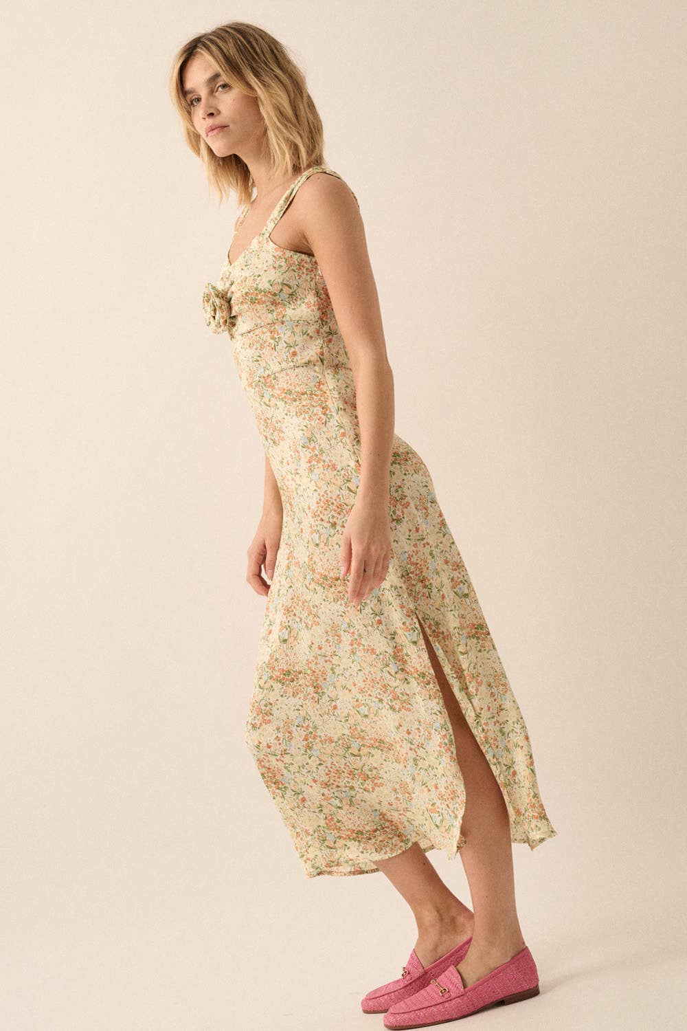 Woman wearing a floral dress on a beige background