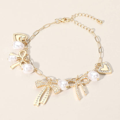 Stone Paved Bow Heart Pearl Charm Station Chain Bracelet